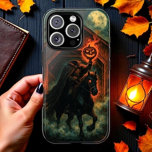 May include: A clear phone case featuring a Halloween-themed design. The artwork depicts a headless horseman riding a black horse, holding a jack-o'-lantern. The background includes a full moon and a spooky, dark landscape. The case has a transparent border.