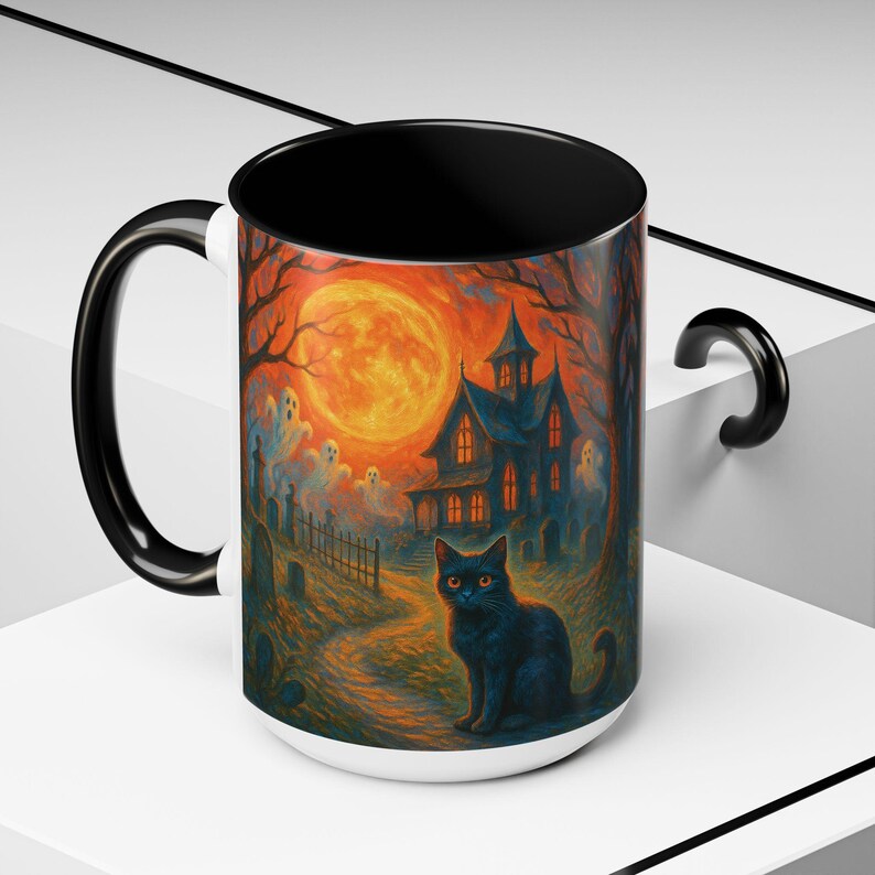 A spooky Halloween mug design featuring a glowing orange moon, eerie ghosts drifting near a gothic haunted house, and a black cat with fiery orange eyes sitting in a graveyard path. Perfect for Halloween lovers, witches, and gothic décor fans, this mug makes a unique fall kitchen piece or haunted holiday gift. Works for coffee, tea, or cocoa. Original design by The Haunted Hollow Co.™.