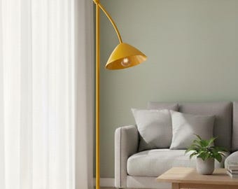 May include: A yellow floor lamp with a round base and a tall, straight pole. The lamp has a curved arm with a conical lampshade and a small spherical accent. The lamp is in a living room setting.