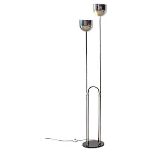 May include: A floor lamp featuring two chrome bowl-shaped shades mounted on thin vertical poles of varying heights. The structure includes a black arched support connected to a circular black base, with a black power cord and a white floor switch.