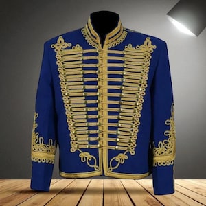 May include: A royal blue jacket with gold-colored embellishments. The jacket features a high collar and is adorned with rows of gold braid and decorative embroidery. The design is symmetrical, with gold detailing on the sleeves and front.