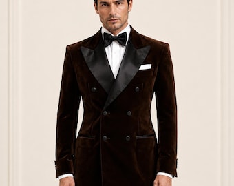 May include: A double-breasted dark brown velvet blazer featuring wide black satin peak lapels, a white dress shirt, and a black bow tie. The jacket includes black buttons, two side pockets with satin trim, and a white pocket square in the chest pocket.