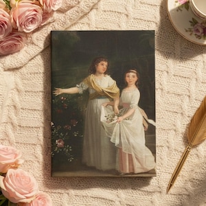May include: A canvas print of a classical painting depicting two young women in white dresses. The print rests on a cream knitted blanket, accompanied by pink roses and a gold quill pen. A teacup and saucer with floral patterns are also visible.
