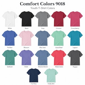 May include: A color chart for Comfort Colors 9018 youth t-shirts, displaying seventeen short-sleeve shirts in various solid colors including white, black, gray, crimson, crunchberry, flo blue, blossom, blue jean, island reef, lagoon, seafoam, violet, washed denim, watermelon, pepper, true navy, and chalky mint.