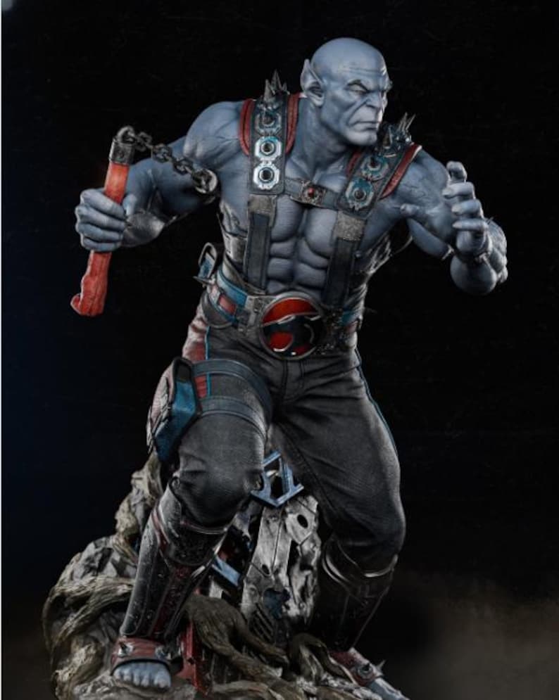 May include: A detailed statue of a muscular, blue-skinned humanoid figure. The figure wears a black and gray outfit with red and blue accents, a belt buckle with a red emblem, and spiked shoulder pads. It holds a red weapon with a chain.