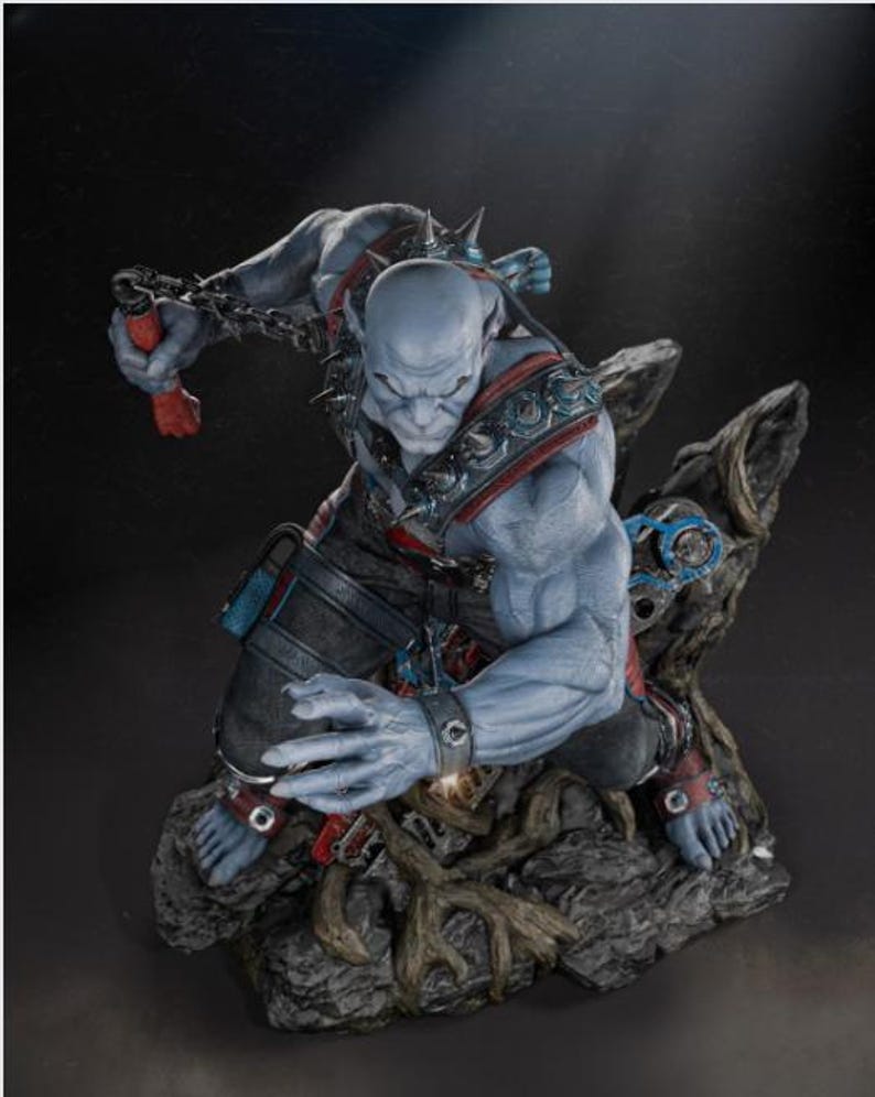 May include: A detailed figurine of a blue-skinned humanoid creature in a dynamic pose. The figure is adorned with spiked shoulder armor, wrist cuffs, and a chain. It is set on a rocky base with intricate details, showcasing a fantasy theme.