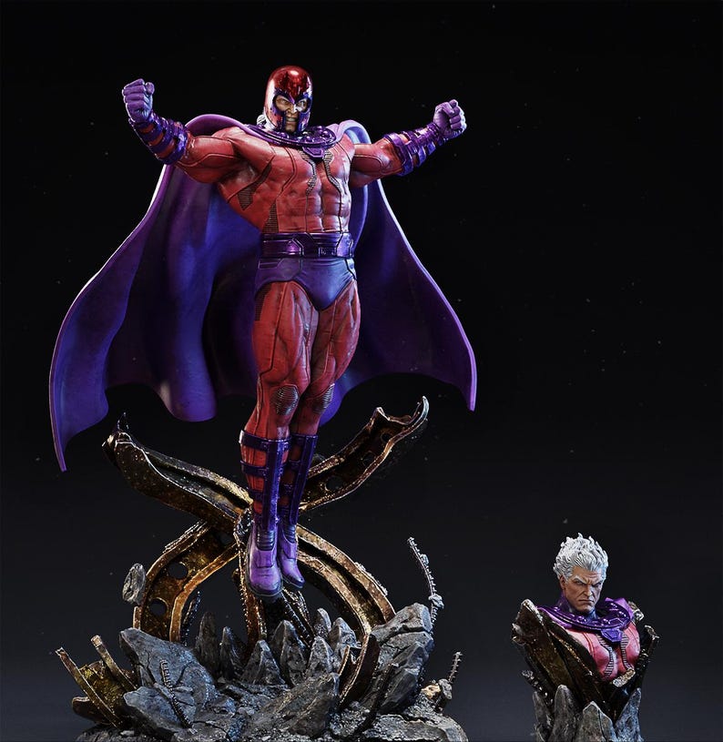 May include: A detailed statue of a superhero in a dynamic pose, wearing a red and purple costume with a flowing cape. The figure is posed with arms raised, atop a metallic, rocky base. A smaller bust of the character is also visible.