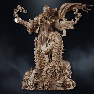 May include: A detailed, tan-colored statue of a character with a mask, cape, and multiple guns. The figure stands atop a base adorned with skulls, bullets, and a shield. The statue has intricate details and a dynamic pose.