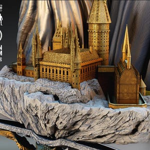 May include: A detailed gold-colored miniature castle model, featuring multiple towers and spires, set on a rocky base. The model is labeled as 1/6 scale and includes the text "RESIN & FDM PORTRAITS".