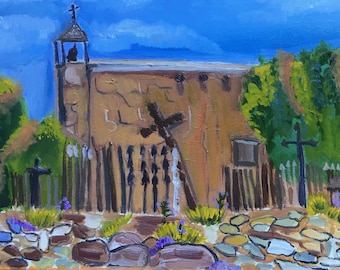 May include: A painting of a brown adobe church with a bell tower and a wooden fence. The church is surrounded by a stone path and green trees. There are several crosses in the foreground.
