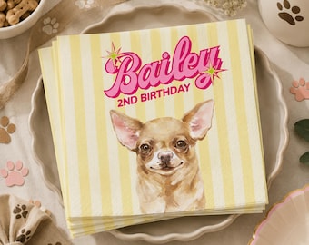May include: A stack of yellow and white striped napkins with the name "Bailey" in pink script and a watercolor illustration of a Chihuahua. The text "2ND BIRTHDAY" is below the name. The napkins are on a white plate.