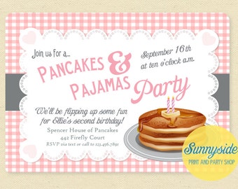 May include: Pink and white gingham patterned invitation with a white lace border. The invitation is for a Pancakes & Pajamas Party. The text on the invitation reads "Join us for a... Pancakes & Pajamas Party" and "September 16th at ten o'clock a.m.". The invitation also includes a drawing of a stack of pancakes with butter and candles on top.
