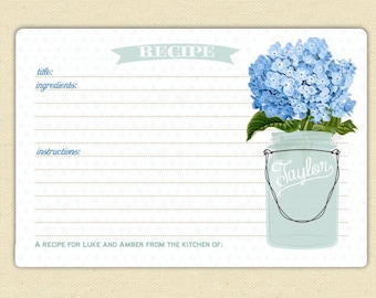 May include: A printable recipe card with a blue hydrangea in a mason jar. The card has lines for the title, ingredients, and instructions. The text at the bottom reads "A recipe for Luke and Amber from the kitchen of:"