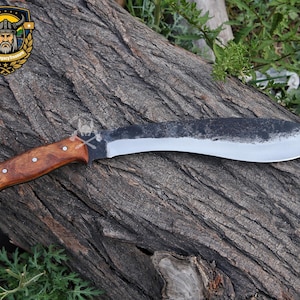 May include: A large, curved blade knife with a wooden handle. The blade has a dark, textured finish on the top edge and a polished, silver edge. The handle is a warm brown color and is secured with rivets. The knife is designed for cutting and chopping.