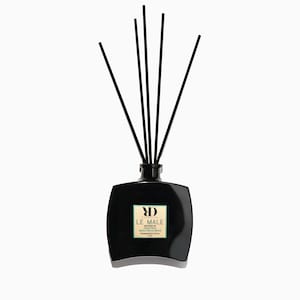 May include: Black rectangular diffuser bottle with black reeds. The bottle has a label with the text "LE MALE" and "FRAGRANCE STICK". The diffuser is designed to release fragrance into the air.