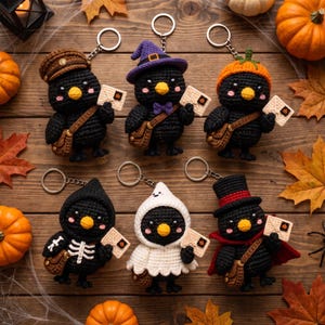 May include: Six crocheted black bird keychains, each holding a small envelope with a pumpkin seal. The birds wear various accessories: a brown cap, a purple witch hat, an orange pumpkin hat, a skeleton costume, a white ghost hood, and a top hat.