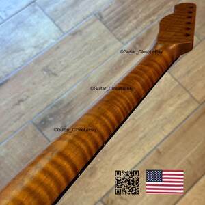 May include: A guitar neck with a flamed maple finish. The neck is a light brown color with darker brown streaks. The headstock has tuning peg holes. The image includes the text "Guitar_Closet eBay", a QR code, and the American flag.