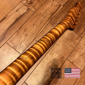 May include: A guitar neck made of light brown wood with a prominent tiger stripe flame grain pattern. The headstock features six tuner holes arranged in a single row. The text Guitar_Closet eBay is visible on the wood surface.