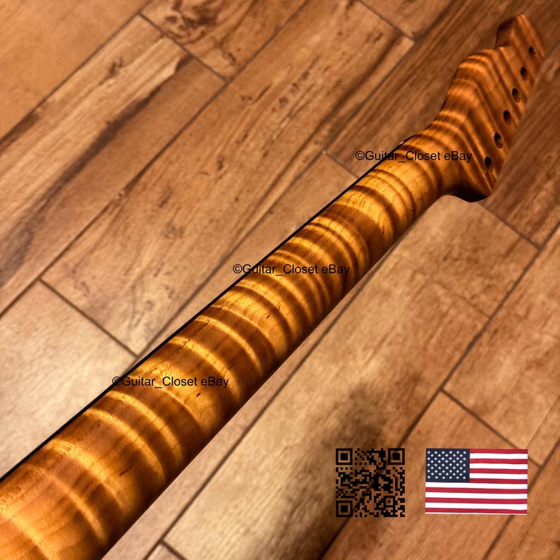 May include: A guitar neck made of light brown wood with a prominent tiger stripe flame grain pattern. The headstock features six tuner holes arranged in a single row. The text Guitar_Closet eBay is visible on the wood surface.