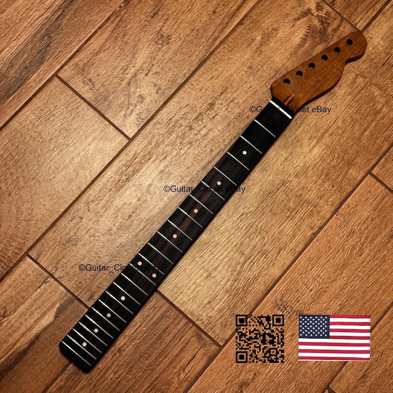 May include: A guitar neck featuring a dark wood fretboard with white dot inlays and silver frets. The headstock is made of light brown wood with six tuning peg holes. The text Guitar_Closet eBay is visible on the surface, along with a QR code.