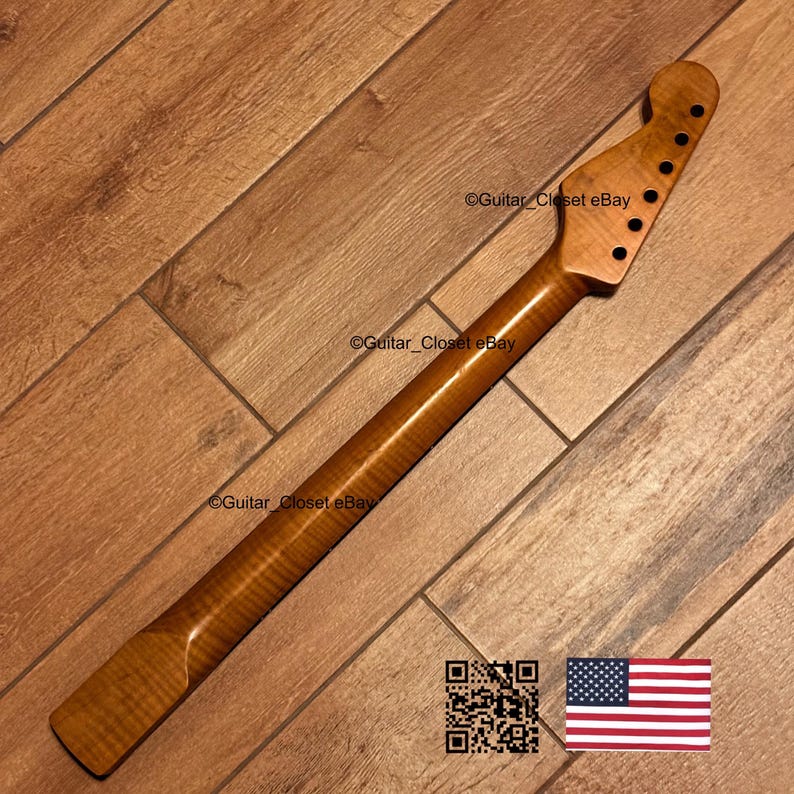 May include: A wooden guitar neck with a natural finish. The neck has a headstock with six tuning peg holes and a smooth, polished surface. The wood grain is visible, and the neck is angled. The image includes a QR code and the American flag.