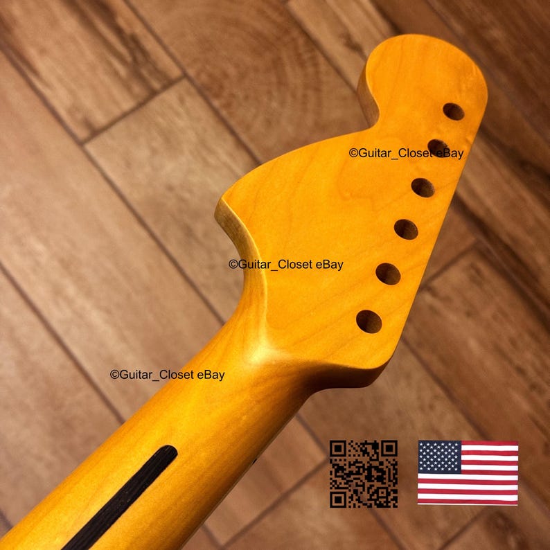 K&ouml;nnte beinhalten: Ein Gitarrenhals mit nat&uuml;rlicher Holzoberfl&auml;che. Die Kopfplatte hat sechs L&ouml;cher f&uuml;r die Stimmwirbel. Der Hals hat einen schwarzen Streifen auf der R&uuml;ckseite. Das Bild enth&auml;lt einen QR-Code und die amerikanische Flagge.