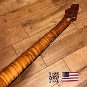 May include: A guitar neck with a flamed maple finish. The neck is a warm brown color with a striped pattern. The headstock has tuning peg holes. The image includes a QR code and an American flag.