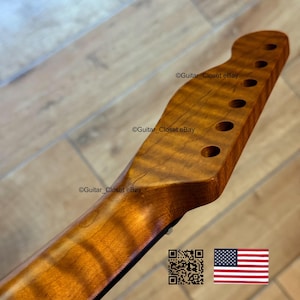 May include: A close-up of a guitar neck made of figured maple wood. The neck has a natural finish, with visible wood grain patterns. It features tuning peg holes and the text "Guitar Closet eBay". An American flag is in the bottom right corner.