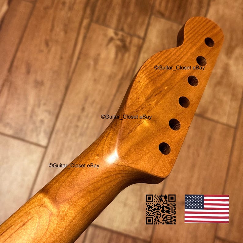 May include: A light brown wooden guitar headstock with a smooth, polished finish and six circular tuning peg holes arranged in a single row. The surface features a visible wood grain pattern and the text Guitar_Closet eBay is printed on it.