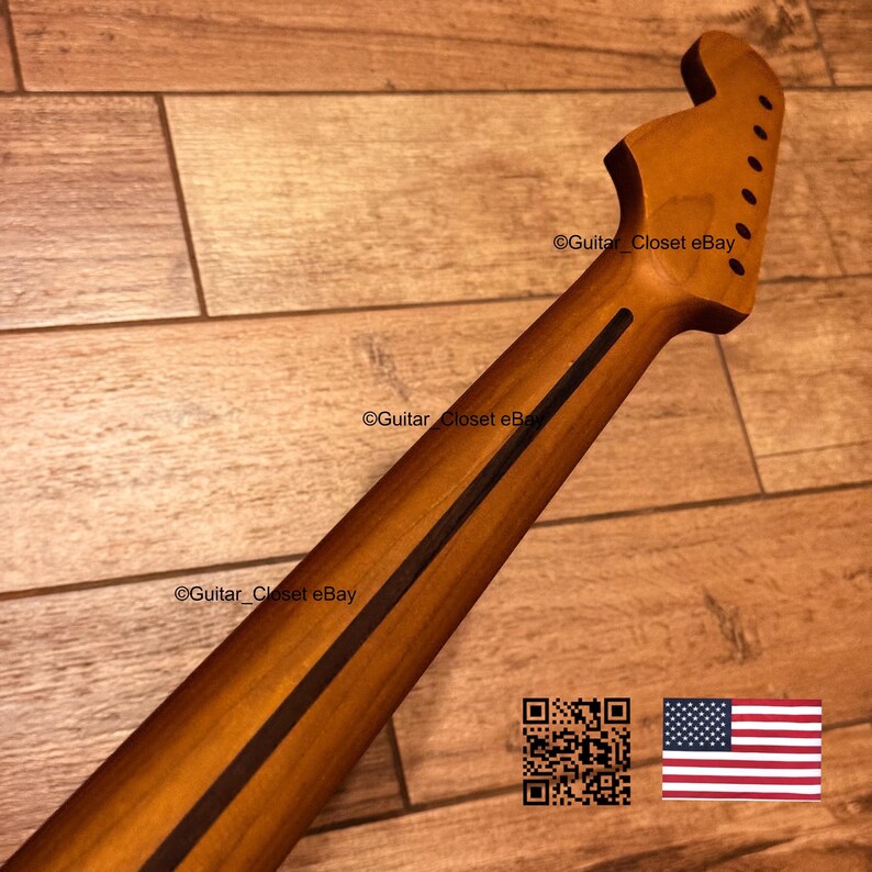 Puede incluir: Un m&aacute;stil de guitarra de madera marr&oacute;n claro con una franja oscura que recorre el centro de la parte posterior. El clavijero incluye seis orificios pretaladrados para las clavijas. El texto Guitar_Closet eBay es visible en el m&aacute;stil y el clavijero.