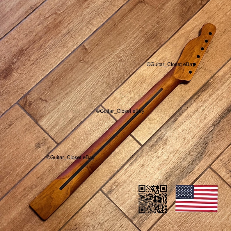 May include: A guitar neck made of wood, with a natural finish. The neck has a dark stripe down the center and a headstock with six tuning peg holes. The image also includes a QR code and a US flag.