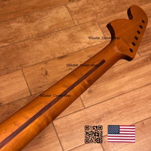 May include: A guitar neck with a natural wood finish, featuring a dark stripe down the center. The headstock has tuning peg holes. The image includes the text "Guitar_Closet eBay" and a QR code and American flag.