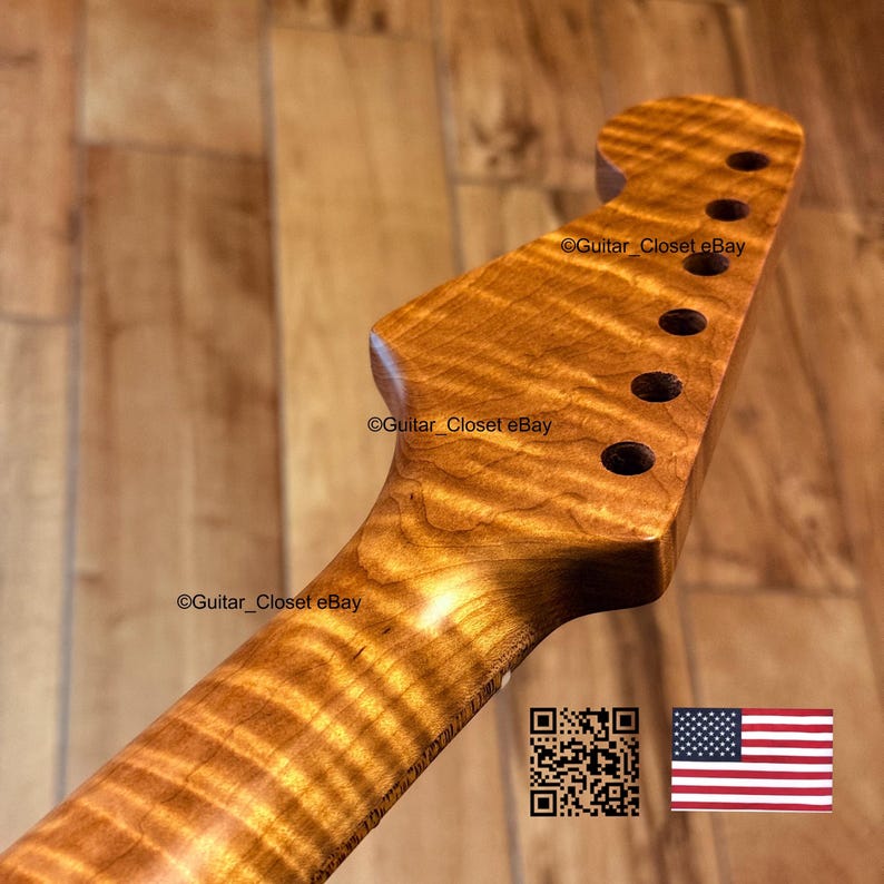 May include: A close-up shot of a guitar neck crafted from flamed maple, showcasing a distinctive wavy wood grain pattern. The headstock features six tuning peg holes. The text "Guitar Closet eBay" is visible. A QR code and the American flag are in the lower right corner.