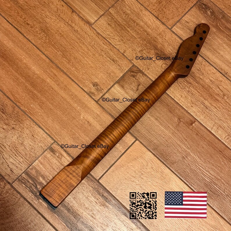 May include: A wooden guitar neck with a flamed maple finish. The neck has a headstock with six tuning peg holes and a dark fretboard. The image includes a QR code and the American flag.