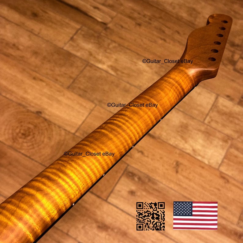 May include: A close-up of a guitar neck with a flamed maple finish. The wood grain has a wavy pattern with shades of amber and brown. The headstock has tuning peg holes. The image includes the text "Guitar Closet eBay" and a QR code and American flag.