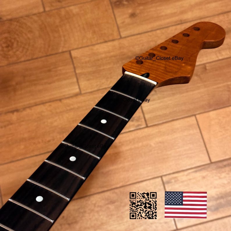 May include: A guitar neck with a dark fretboard and a light brown headstock. The fretboard has white dot inlays. The headstock has tuning peg holes. The text "Guitar Closet eBay" is visible.