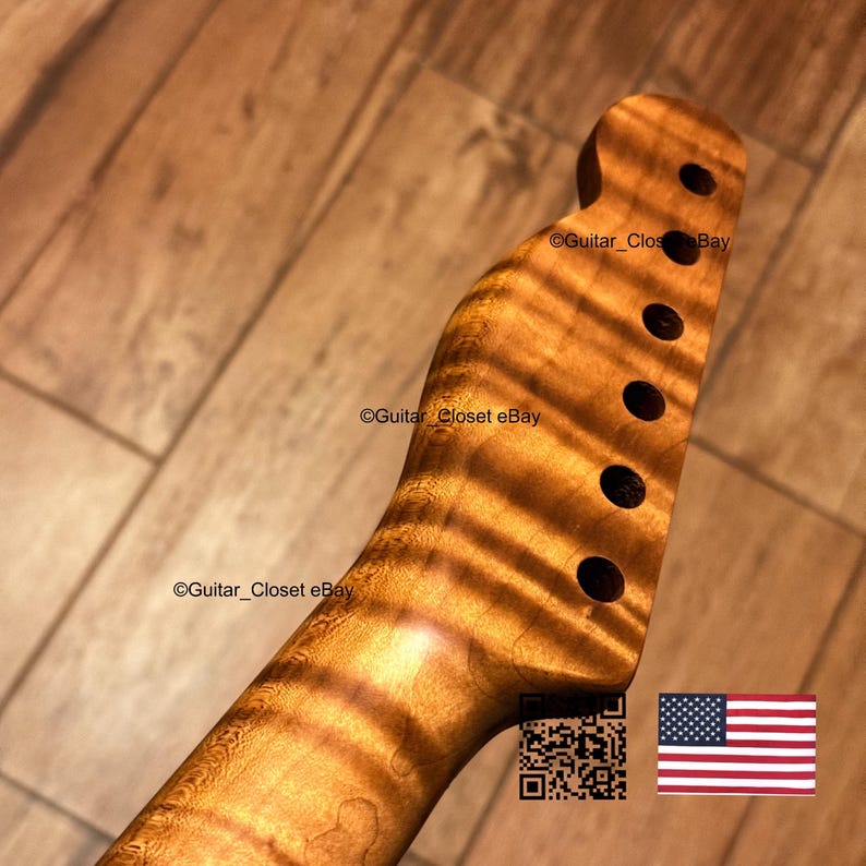 May include: A guitar neck with a headstock featuring six tuner holes, crafted from light brown wood with a prominent tiger stripe grain pattern. The text Guitar_Closet eBay is visible on the wood, alongside a QR code and a small American flag icon.