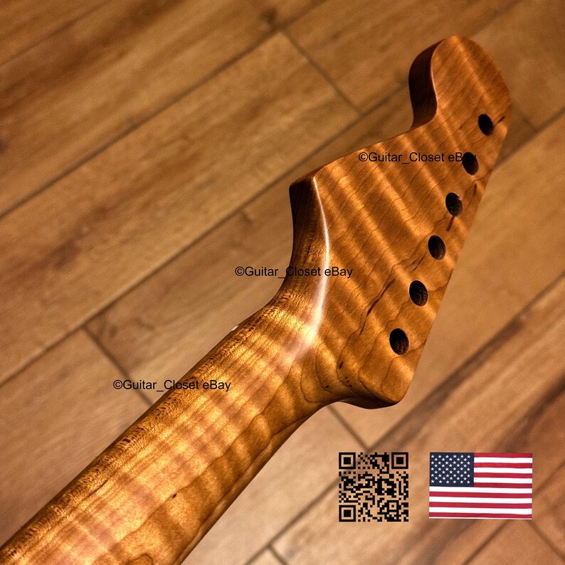 K&ouml;nnte beinhalten: Ein Gitarrenhals mit Kopfplatte in nat&uuml;rlicher Holzmaserung und sechs L&ouml;chern f&uuml;r Stimmmechaniken. Das Holz weist ein ausgepr&auml;gtes Tigerstreifenmuster &uuml;ber die gesamte L&auml;nge von Hals und Kopfplatte auf. Der Text Guitar_Closet eBay ist sichtbar.