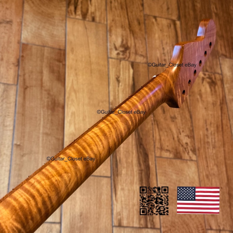 May include: A guitar neck with a flamed maple finish. The wood grain has a wavy pattern with shades of brown and amber. The headstock has tuning peg holes. The image includes a QR code and a US flag.