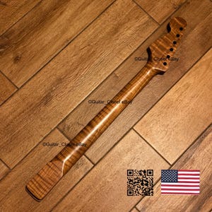 K&ouml;nnte beinhalten: Ein Gitarrenhals mit einer nat&uuml;rlichen braunen Oberfl&auml;che und einer sichtbaren Tigerstreifen-Maserung aus geflammtem Ahornholz. Die Kopfplatte enth&auml;lt sechs vorgebohrte L&ouml;cher f&uuml;r Stimmwirbel. Der Text Guitar_Closet eBay ist sichtbar.