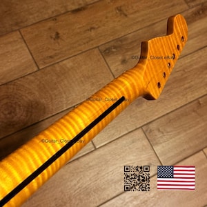 May include: A guitar neck with a flamed maple finish. The neck has a dark stripe down the center and tuning peg holes at the headstock. The image includes a QR code and a small American flag.