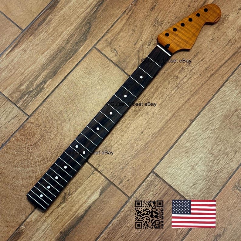 May include: A guitar neck with a flamed maple headstock and a dark fretboard with white dot inlays. The neck is angled on a wooden surface. The text "Guitar Closet eBay" is visible. An American flag is in the bottom right corner.