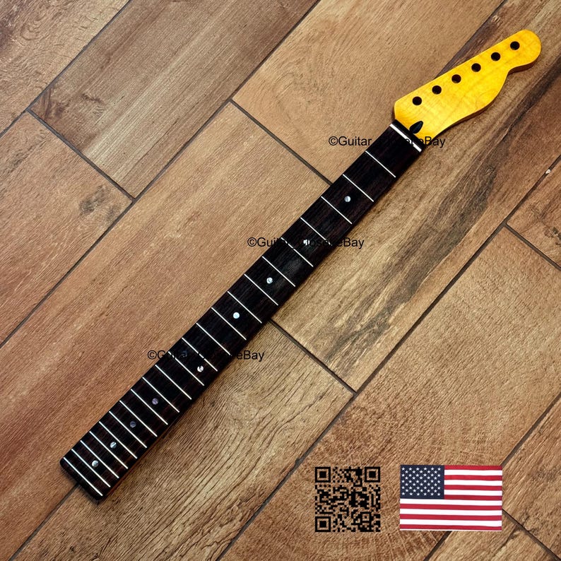 Puede incluir: Un m&aacute;stil de guitarra con pala de arce y diapas&oacute;n de palisandro oscuro. El diapas&oacute;n tiene incrustaciones blancas. El m&aacute;stil est&aacute; sobre un fondo de madera. La pala tiene seis agujeros para clavijas.