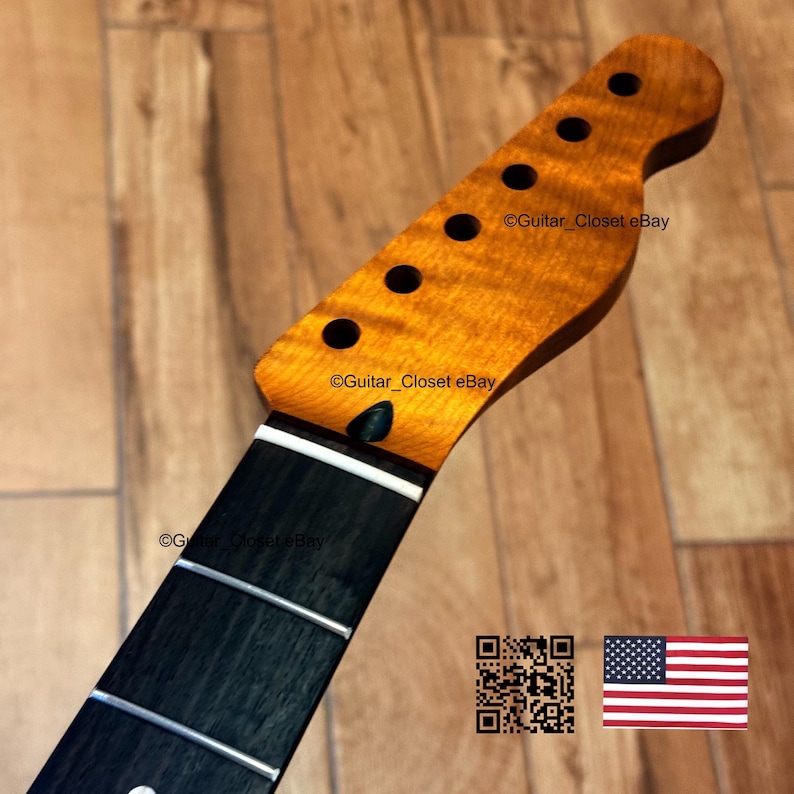 May include: A guitar neck with a flamed maple headstock and a black fretboard. The headstock has six tuning peg holes and a dark finish. The fretboard has silver frets. The text "Guitar_Closet eBay" is visible. An American flag is in the image.