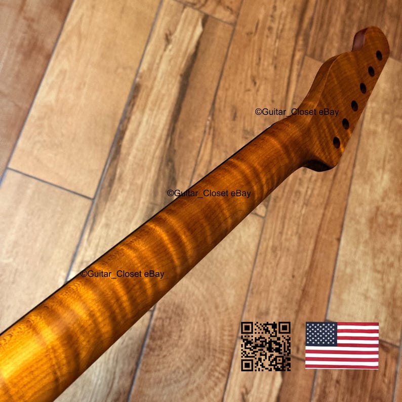May include: A guitar neck with a flamed maple finish. The neck is a warm amber color with dark brown grain patterns. The headstock has six tuning peg holes. The text "Guitar_Closet eBay" is visible.