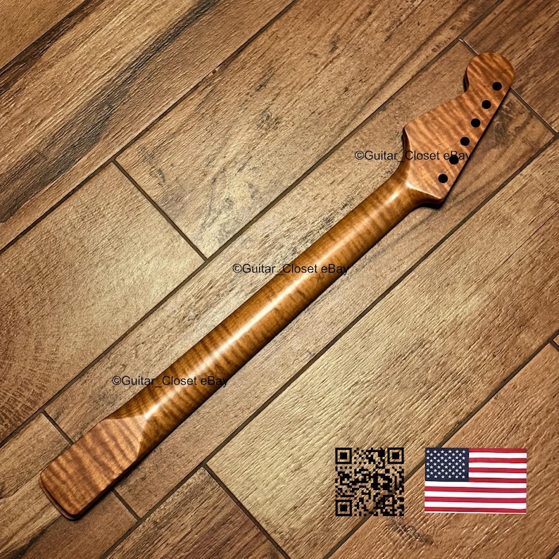 Puede incluir: Un m&aacute;stil de guitarra fabricado en madera de arce flameado con un acabado &aacute;mbar natural. El clavijero presenta seis orificios pretaladrados para las clavijas. La veta de la madera muestra un patr&oacute;n de rayas de tigre a lo largo.