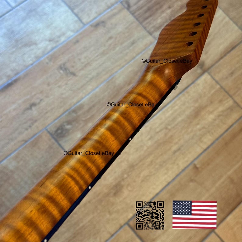 May include: A close-up of a guitar neck with a flamed maple finish. The wood grain has a prominent, wavy pattern. The headstock has pre-drilled holes for tuning pegs. The image includes a QR code and an American flag.