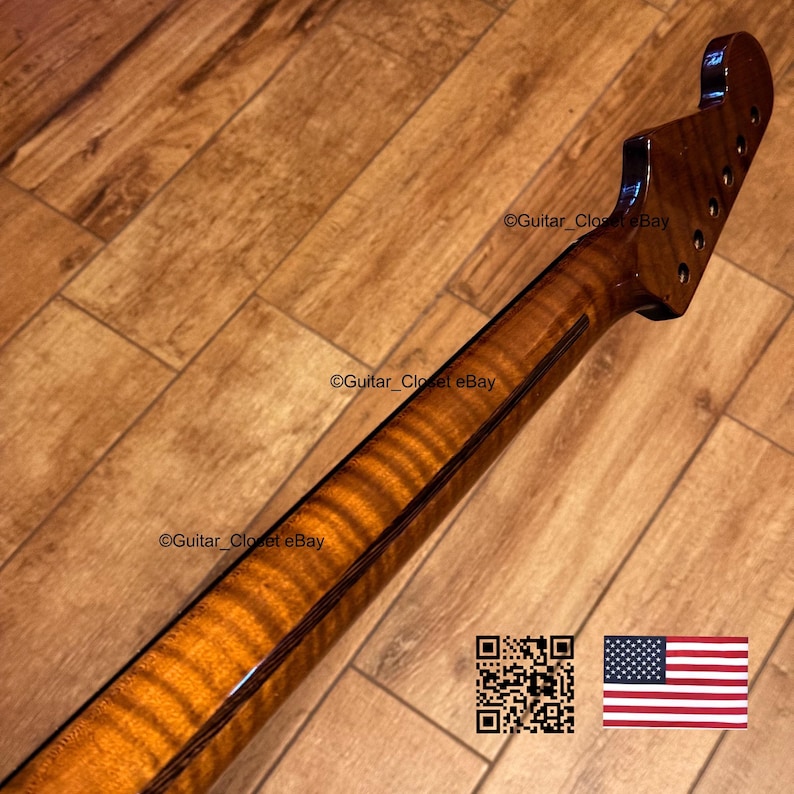 May include: A close-up of a guitar neck with a flamed maple finish. The neck is a warm amber color with dark brown stripes. The headstock has tuning peg holes. The image includes a QR code and an American flag.
