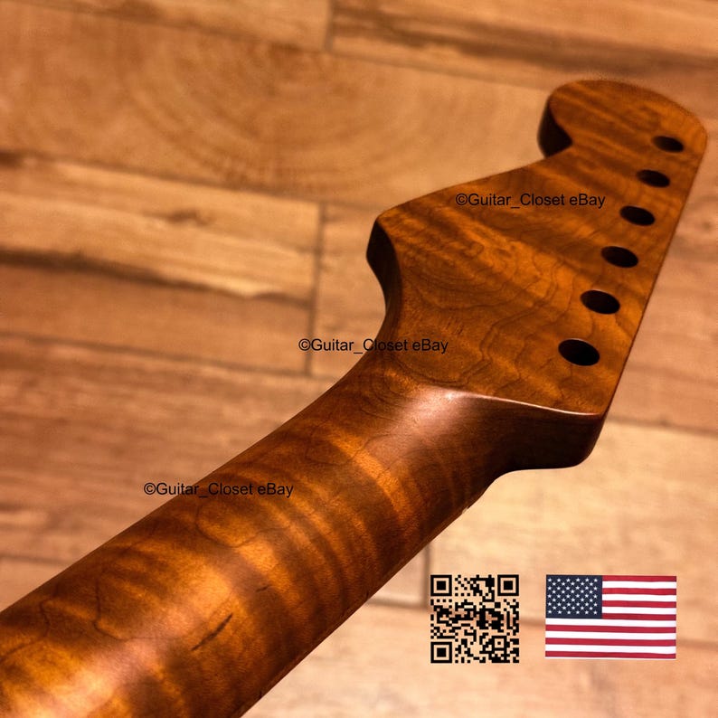 May include: A guitar neck with a natural wood grain finish and a headstock featuring six tuner holes. The wood displays a distinct wavy pattern throughout the length of the neck. The text Guitar_Closet eBay appears on the surface.