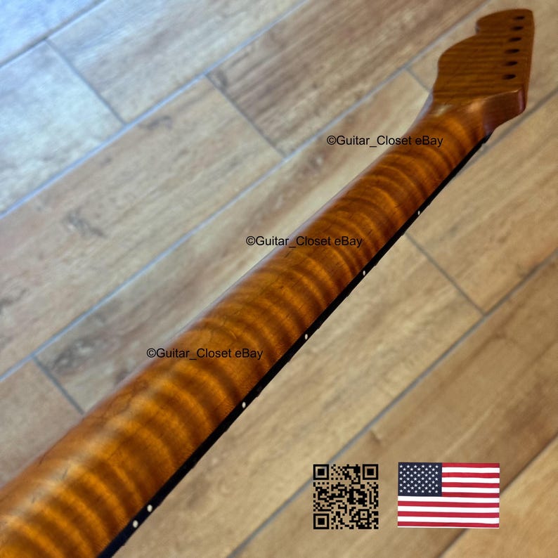 May include: A close-up of a guitar neck with a flamed maple finish. The neck is a warm, amber color with a striped pattern. The fretboard is black with white dot inlays. The text "Guitar_Closet eBay" is visible.